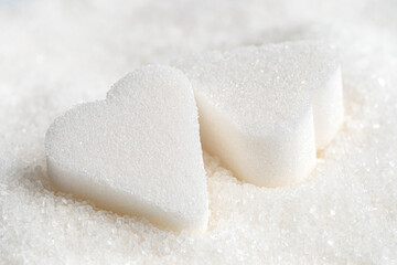 Fototapeta na wymiar White sugar hearts and granulated sugar.
