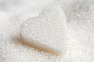 Fototapeta na wymiar White sugar heart and granulated sugar.