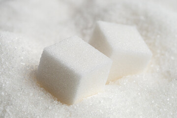 White sugar cubes and granulated sugar.
