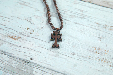 wooden necklace cross on table