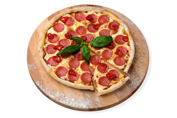 Whole Spicy Italian Pepperoni Pizza with salami slices, fresh chilli pepper and mozzarella cheese served with fresh basil on wooden plate served with culinary flour and spices, isolated on white
