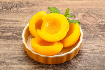 Sweet ripe canned peaches with mint