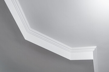 Detail of corner ceiling with intricate crown molding. Suspended ceiling and drywall construction...