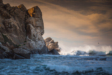 Stormy Pacific ocean and Morro Rock at sunset. Morro Bay State Park, California coastline