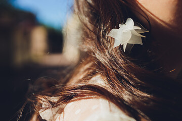 Detail of young woman wearing beautiful luxury earring.