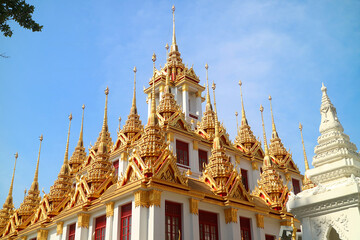 Fototapeta premium Spectacular Golden Spires of the Historic Loha Prasat (Iron Castle) inside Wat Ratchanatdaram Temple Located in Bangkok Old City, Thailand