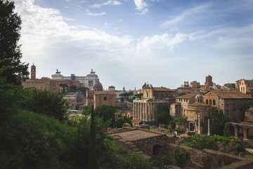 Fototapeta na wymiar A landscape shot of the ancient part of the city of Rome in Italy. The view is of a part of the forum romanum with all the typical traditional roman architectural styles embedded into the buildings.