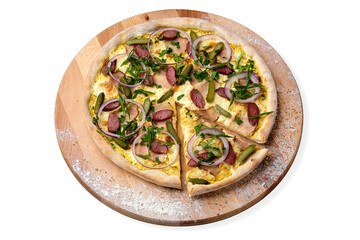 Whole rustic Pizza with pickled cucumber, hunting sausage, bacon, Spanish onion Rings served on wooden plate served with culinary flour and spices, isolated on white background
