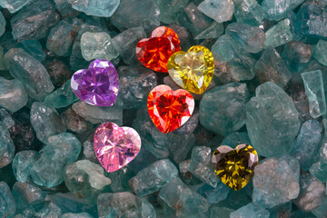 colorful of diamond heart shaped are on raw sky blue gemstones