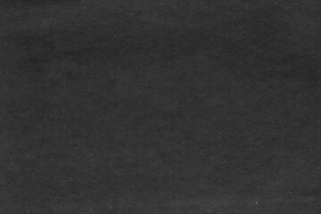 Cardboard black abstract texture close-up. Dark old paper background. Grunge concrete wall. Vintage blank wallpaper.