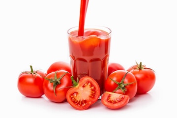 Tomato juice in a glass and tomatoes with green sepals