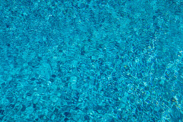 Blue ripped water in swimming pool. Surface of blue swimming pool, background of water in swimming pool. Water swimming pool texture and surface water on pool. Blue ripped water in swimming pool.