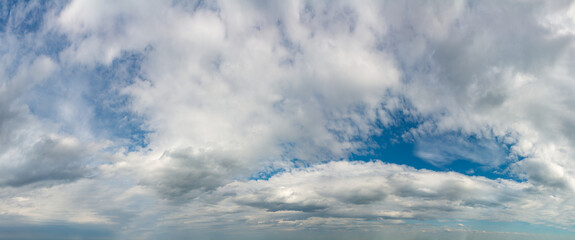 Fantastic clouds against blue sky, panorama