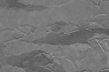 Cardboard black abstract texture close-up. Dark old paper background. Grunge concrete wall. Vintage blank wallpaper.