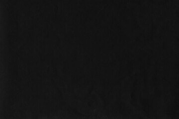 Cardboard black abstract texture close-up. Dark old paper background. Grunge concrete wall. Vintage blank wallpaper.