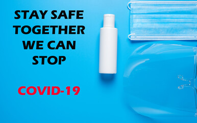 A picture of face shield, mask and hand sanitizer with the word STAY SAFE. TOGETHER. WE CAN STOP..COVID-19 on blue background.