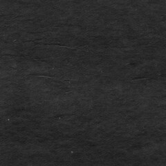 Cardboard black abstract texture close-up. Dark old paper background. Grunge concrete wall. Vintage blank wallpaper.