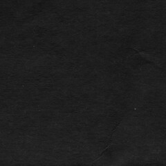 Cardboard black abstract texture close-up. Dark old paper background. Grunge concrete wall. Vintage blank wallpaper.