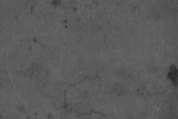 Cardboard black abstract texture close-up. Dark old paper background. Grunge concrete wall. Vintage blank wallpaper.