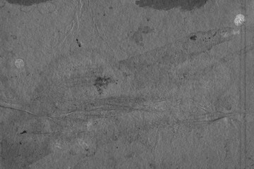 Cardboard black abstract texture close-up. Dark old paper background. Grunge concrete wall. Vintage blank wallpaper.