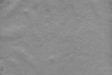 Cardboard black abstract texture close-up. Dark old paper background. Grunge concrete wall. Vintage blank wallpaper.