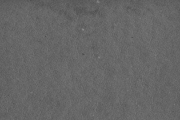 Cardboard black abstract texture close-up. Dark old paper background. Grunge concrete wall. Vintage blank wallpaper.