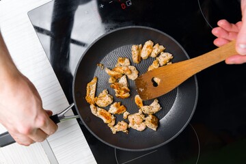 Preparing low fat fried chicken for dinner on induction plates