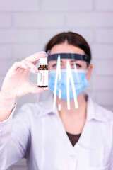 Vial with covid 19 vaccine, in the hands of a nurse.