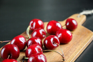 Fresh cherries on a wooden cutting board