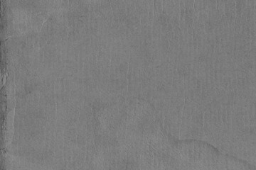 Cardboard black abstract texture close-up. Dark old paper background. Grunge concrete wall. Vintage blank wallpaper.