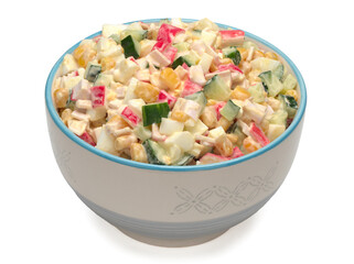 Salad with corn, crab sticks, cucumbers, eggs and mayonnaise in a bowl on white background