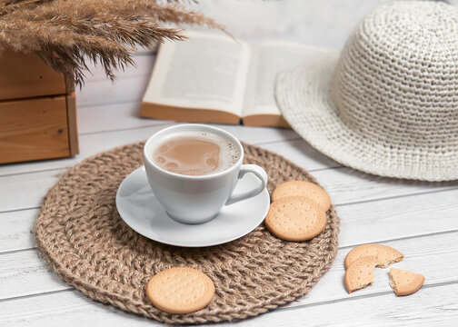 Cappuccino with biscuits on jute table mat