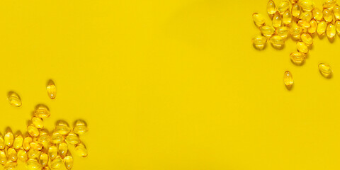 Fish oil capsules on a yellow background around the edges. Place for your text. Medical concept.