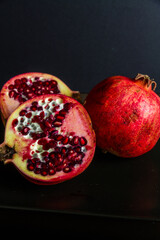 One whole and two half pomegranates.