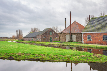 Old farm with barn and haystack in the Dutch polder landscape