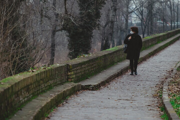 Lady walks along the river during covid-19
