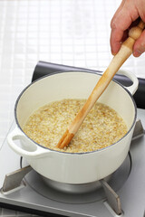 making traditional Scottish porridge by wooden spurtle