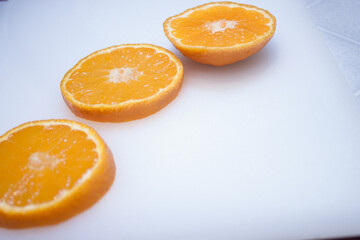 Isolated flying oranges. Falling sliced orange fruit isolated on white background with clipping path