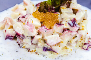 Octopus tartare with pike caviar on a plate
