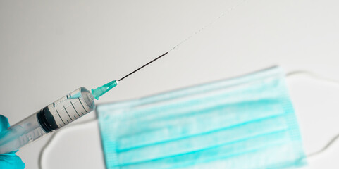 healthcare and medical concept - close up of female doctor holding syringe with injection
