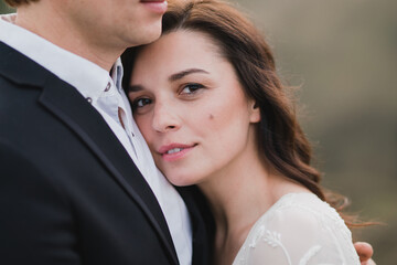 Romantic, young and happy caucasian couple in wedding clothes on the background of beautiful nature. Love, relationships, romance, happiness concept. Bride and groom traveling  together.
