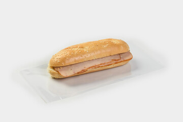 baguette with ham on a light background