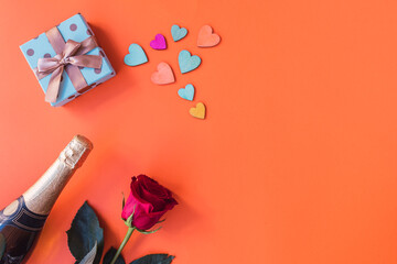 Orange background, with rose, hearts, champagne, copy space