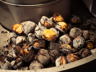 roasted chestnuts on a stand on the market