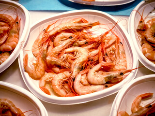 snack of prawns, gambas on a plastic-plate in a fair