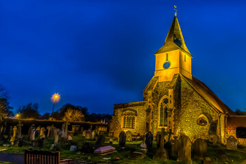 Peace and solitude of a medieval church and cemetery at night in Sanderstead, Croydon, UK in winter