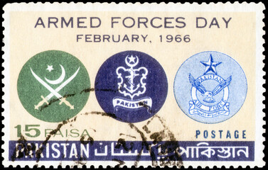 Postage stamp issued in the Pakistan with the image of the Army, Navy and Air Force Crests. From the series on Armed Forces Day, circa 1966