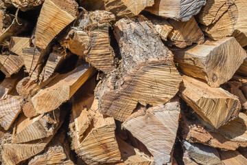 Cut wood, firewood for the winter. Cut logs fire wood and ready pieces of wood for heating wood. Lumber industry. Heating season, winter season. Renewable resource of energy. Environmental concept.