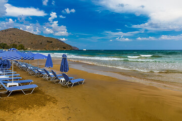 View of sunbeds awaiting tourists at the Greek island resort of Georgioupolis on Crete north coast. Georgioupoli is a resort village and former municipality in the Chania regional unit, Crete, Greece.