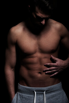 Fitness, man with athletic, muscular body, dark, on black background